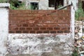 Brick fence on a stucco wall