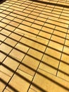 A brick floor with a pattern of squares and a shadow cast by a window