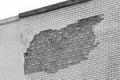 Brick grey broken masonry wall with cement white concrete damaged facade background texture old