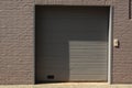 brick grey gate shadow garage wall Royalty Free Stock Photo