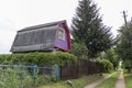 brick house with an attic sheathed in lilac siding Royalty Free Stock Photo