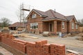 Brick house construction project with building background Royalty Free Stock Photo
