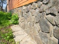 Brick house foundation wall from wild stone for waterproofing protection