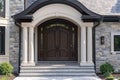 Brick house with a grand arched porch and a front door Royalty Free Stock Photo