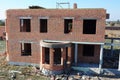 Brick house under construction. Luxury brick house wall construction with no roof