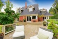Brick house with walkout deck. Patio area with wicker chairs Royalty Free Stock Photo