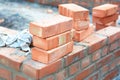 Brick house wall constuction with stack of red bricks. Building house brick wall concept