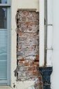 Brick House wall with flaking plaster