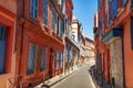 Brick houses on narrow street of Toulouse, France