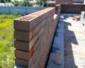 Brick laying in the wall at a construction site at home