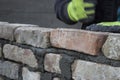 Brick mason laying old brick