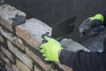 Brick mason using trowel to spread a mortar 2