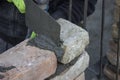 Brick mason using trowel to spread a mortar