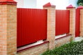 Brick and Metal red Fence with Door and Gate of Modern Style Design Metal Fence Ideas Royalty Free Stock Photo