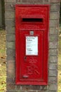 A brick mounted ER post box in a village