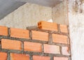 Brick orange wall install laying inside room partition in construction site