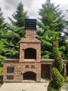 brick outdoor barbecue oven in the garden. Stone garden oven for grill in a backyard Royalty Free Stock Photo