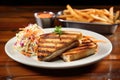 brick-pressed grilled sandwich with a side of coleslaw