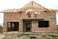 Brick residential house with wooden roof under construction Royalty Free Stock Photo