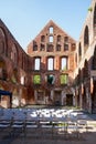Brick ruin of a medieval monastery with seating arrangements for