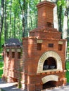 Brick russian stove in green city park