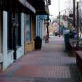 Brick sidewalk in Jonesboro, Arkansas, with a graffiti mural of a woman in the background