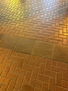 A brick sidewalk with a shiny, reflective surface Royalty Free Stock Photo