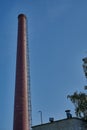 Brick smoke stack against the blue sky. Royalty Free Stock Photo