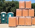 Brick stacks and portable toilets at the construction site