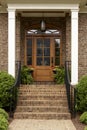 Brick staircase leading up to a brown front door