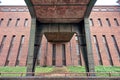 Brick and Steel Pillar of a Bridge, in front of an old Industry Building Royalty Free Stock Photo