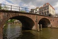 Brick stone arch bridge over `oudegracht` canal Utrecht