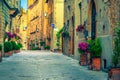 Brick and stone houses decorated with colorful flowers, Pienza, Italy Royalty Free Stock Photo