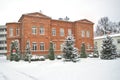 Brick stone mansion in a snow covered garden