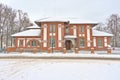 Brick stone mansion in a snow covered garden