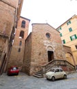 Brick and stone walled small church and street view from the historical Italian city of Siena, Italy Royalty Free Stock Photo