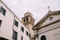 Closeup of the facade of a building, on the streets of Venice, Italy. The brick tower of the bell tower towers over Royalty Free Stock Photo