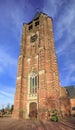 Brick tower of Saint Michel church against blue sky, Ravels, Flanders, Belgium