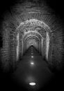 Brick tunnel archway made of red bricks as a passage between the two wings of a medieval castle. Granite stone an brick Royalty Free Stock Photo