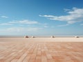 a brick walkway on a sandy beach with a blue sky in the background Royalty Free Stock Photo