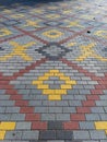 A brick walkway with a yellow and red pattern on it Royalty Free Stock Photo