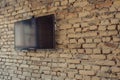 brick wall backdrop with a mounted flatscreen for presentations