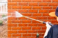 Pressure washer using water to clean a dirty brick wall on a house Royalty Free Stock Photo
