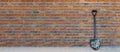 Brick wall of brown color with shovel, wide panorama of masonry. Texture of old dark brown and red brick wall panoramic background Royalty Free Stock Photo