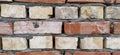 Brick wall. Ceramic masonry or fence. Old, uneven brick, covered in moss and mold in some places. The texture of the stone or Royalty Free Stock Photo