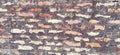 Brick wall. Ceramic masonry or fence. Old, uneven brick, covered in moss and mold in some places. The texture of the stone or Royalty Free Stock Photo
