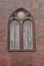 Brick wall of the Church with beautiful arched stained glass window. Beautiful architecture. Details. Royalty Free Stock Photo