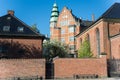 brick wall, church and houses at sunny day Royalty Free Stock Photo