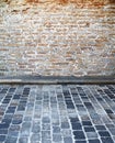 Brick wall and cobblestone street Royalty Free Stock Photo