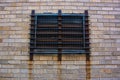 Brick wall with covered and barred window vent